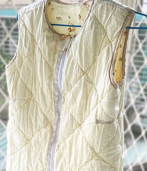 Traditional quilted sleeping vest hanging to dry