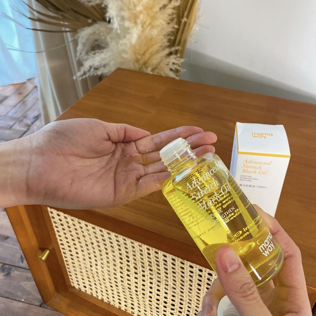 Amanda pouring Mamaway Advanced Stretch Mark Oil