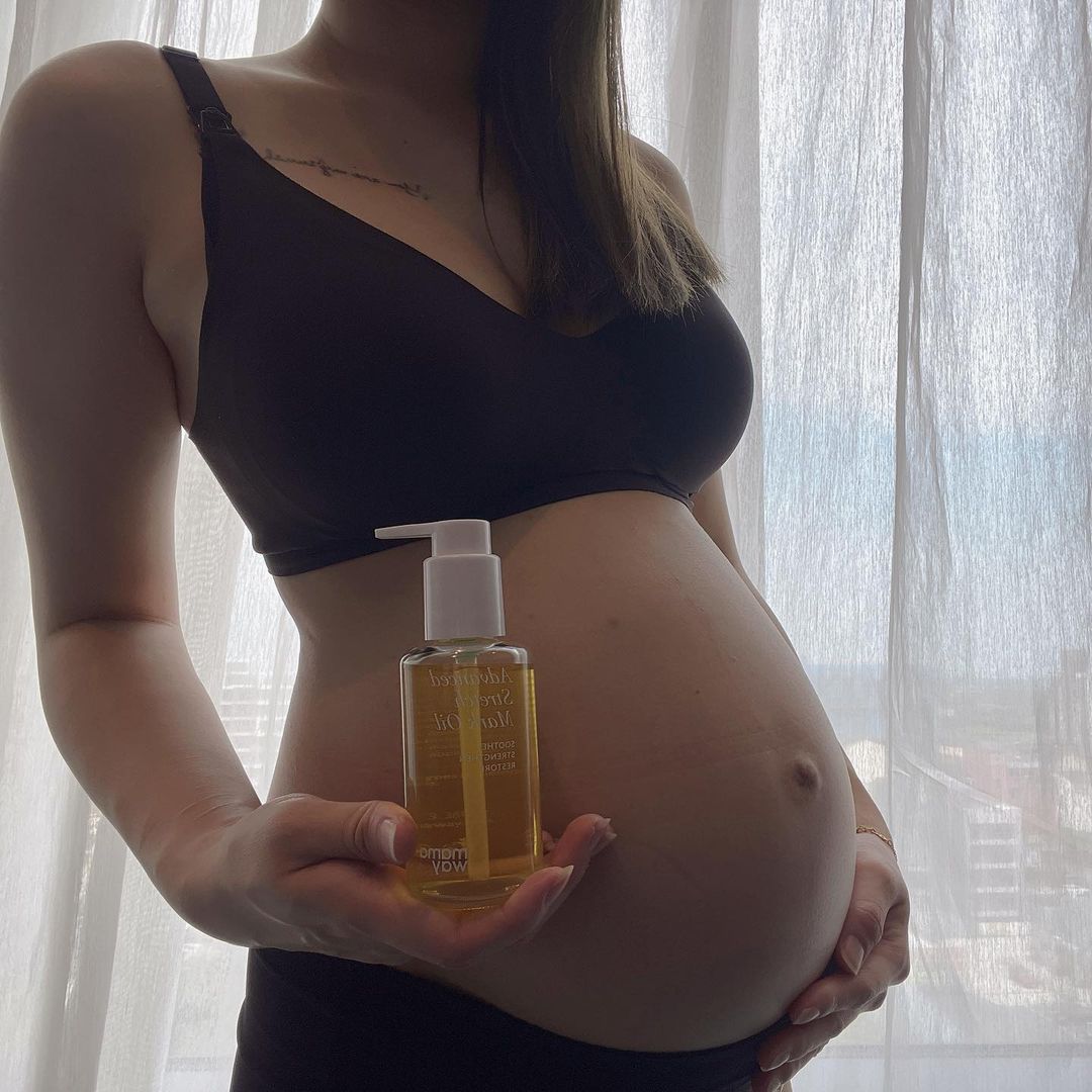 Olivia holding Mamaway Advanced Stretch Mark Oil